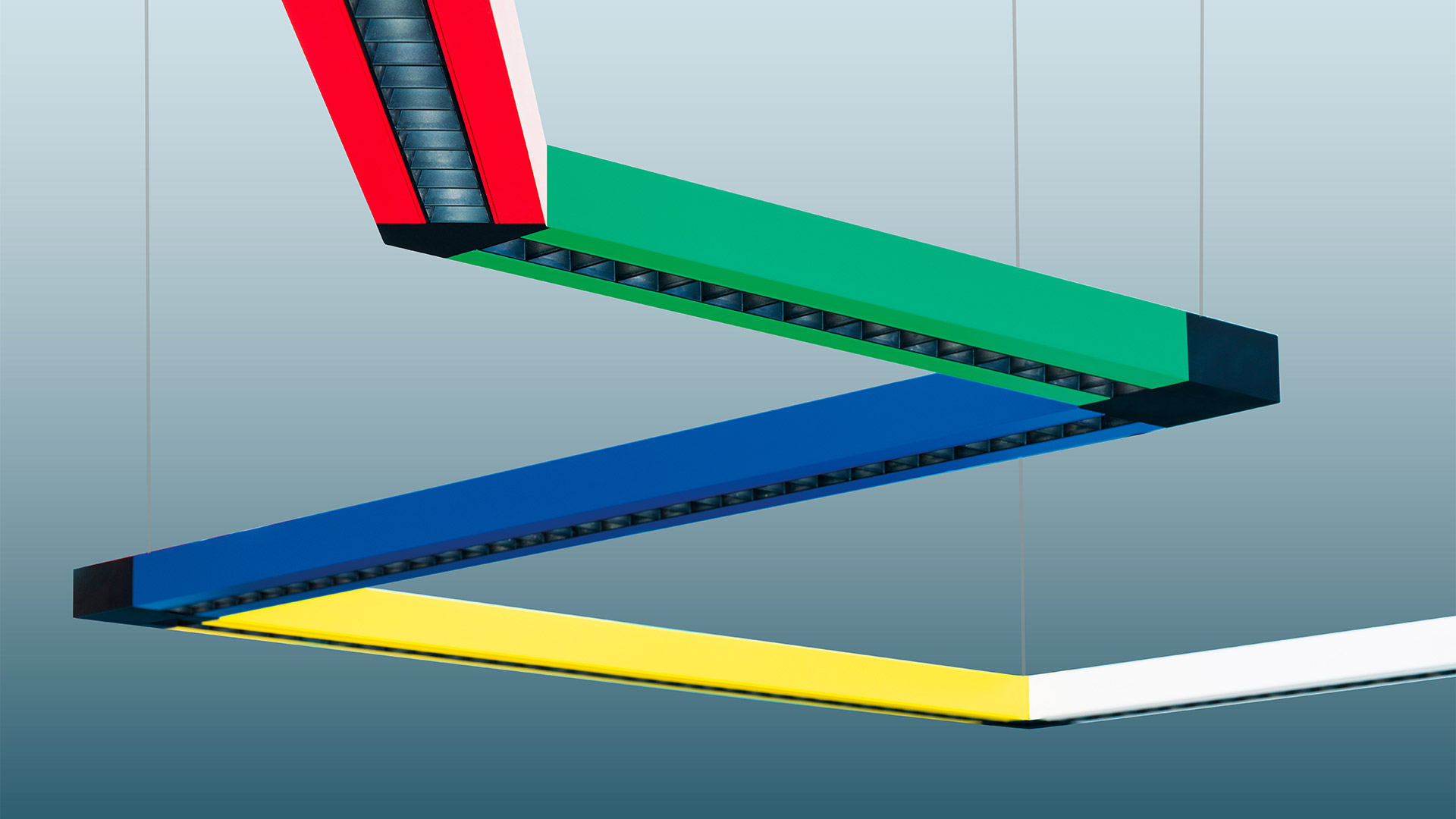 Artemide Katà Métron suspended track system with two black adjustable LED spotlights mounted on blue and green rails