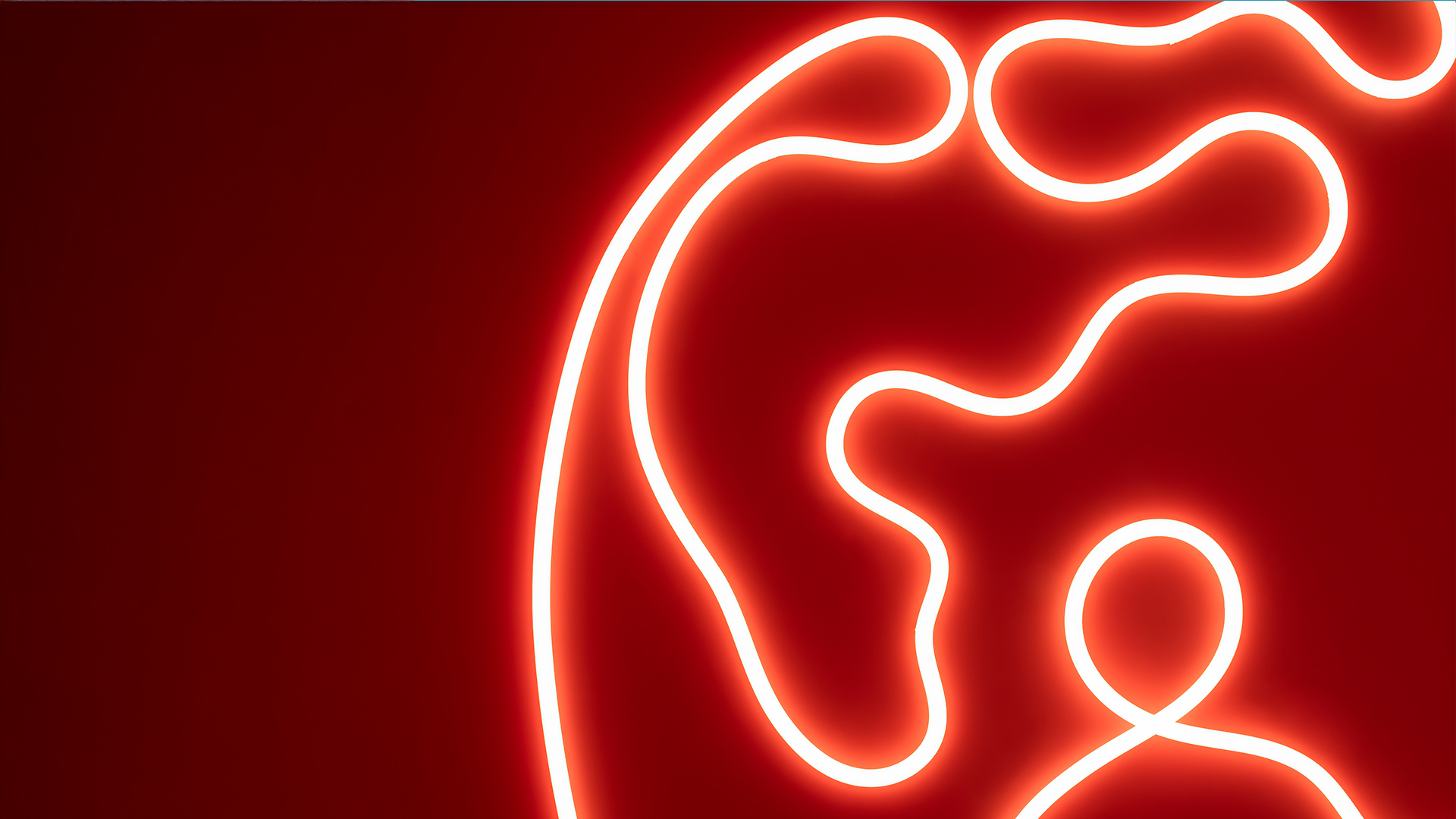 Glowing red neon light forming a continuous single-line abstract female face profile against a dark red background