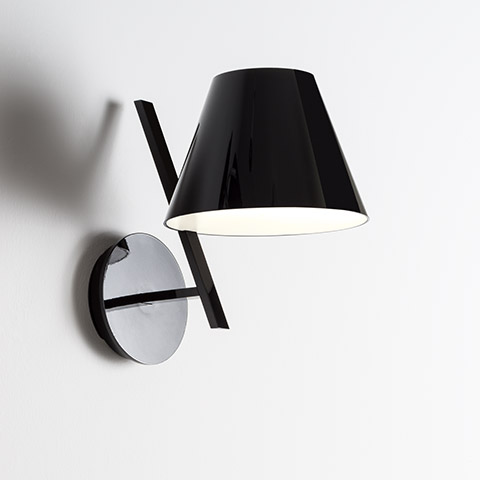 Artemide La Petite Wall lamp: glossy black conical shade with white interior, mounted on a chrome circular wall bracket with angled arm