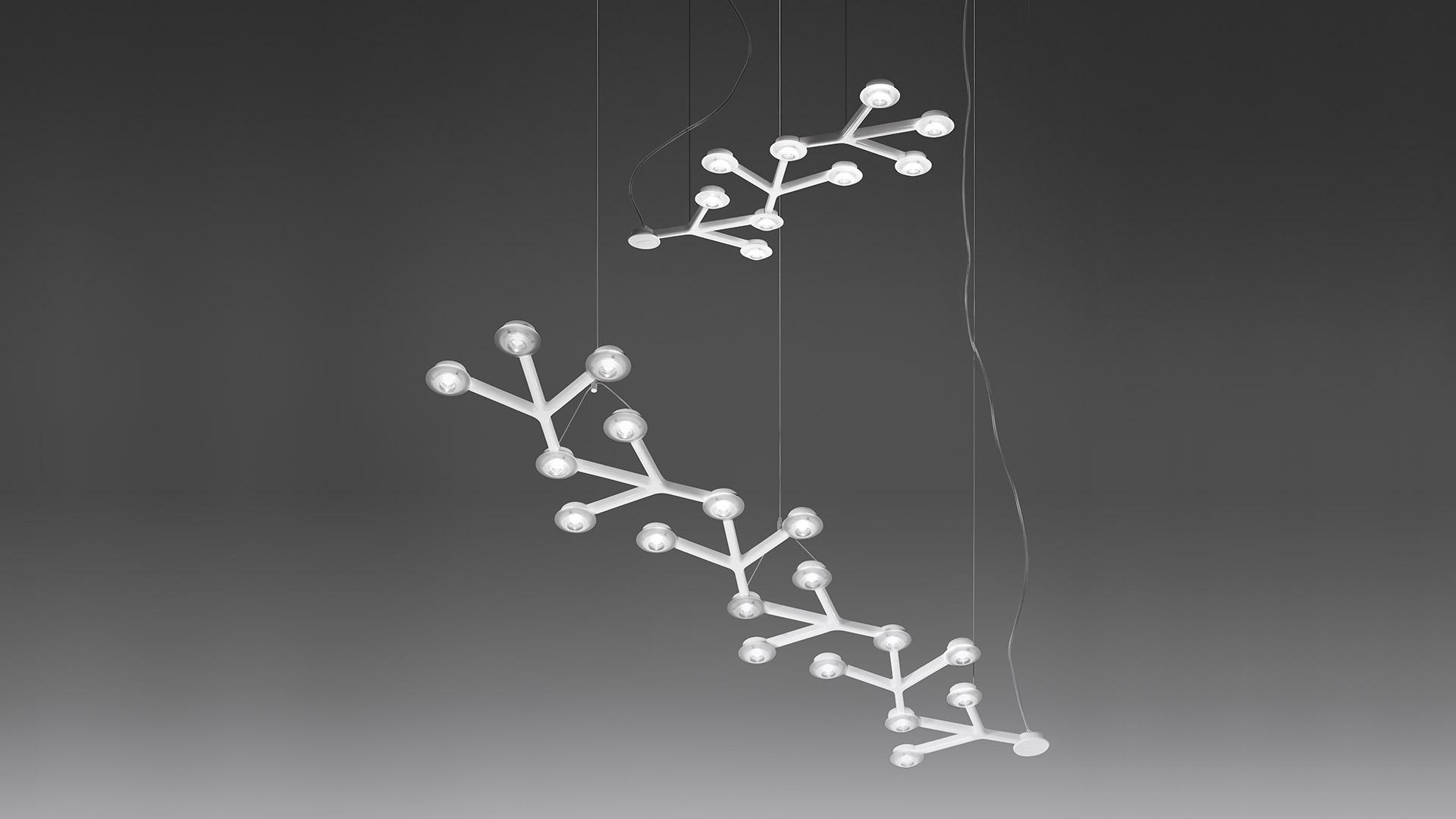 Artemide Led Net Linear pendant lamps: two branch-shaped fixtures with spherical LED nodes suspended by thin cables against grey background