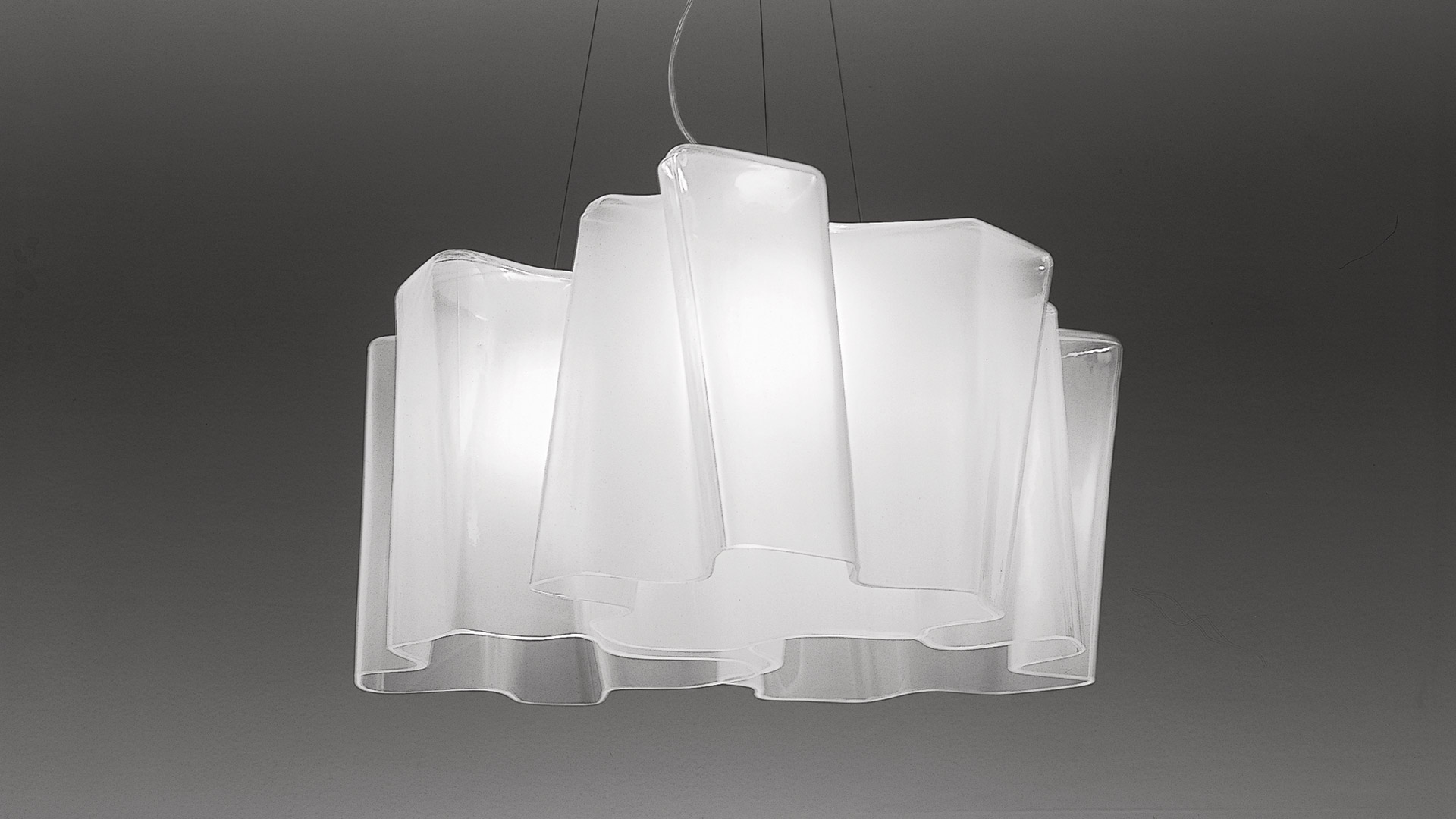 Artemide Logico suspension 3x120°: three overlapping white opal glass shades arranged radially, creating a cloud-like pendant lamp