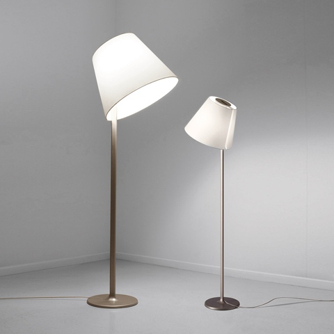 Two Artemide Melampo Terra floor lamps with tilted white conical shades on slender bronze stems, one tall and one shorter