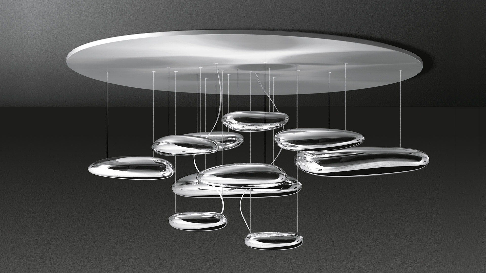 Artemide Mercury ceiling lamp: multiple transparent glass disc-shaped diffusers suspended by thin cables from a large circular canopy