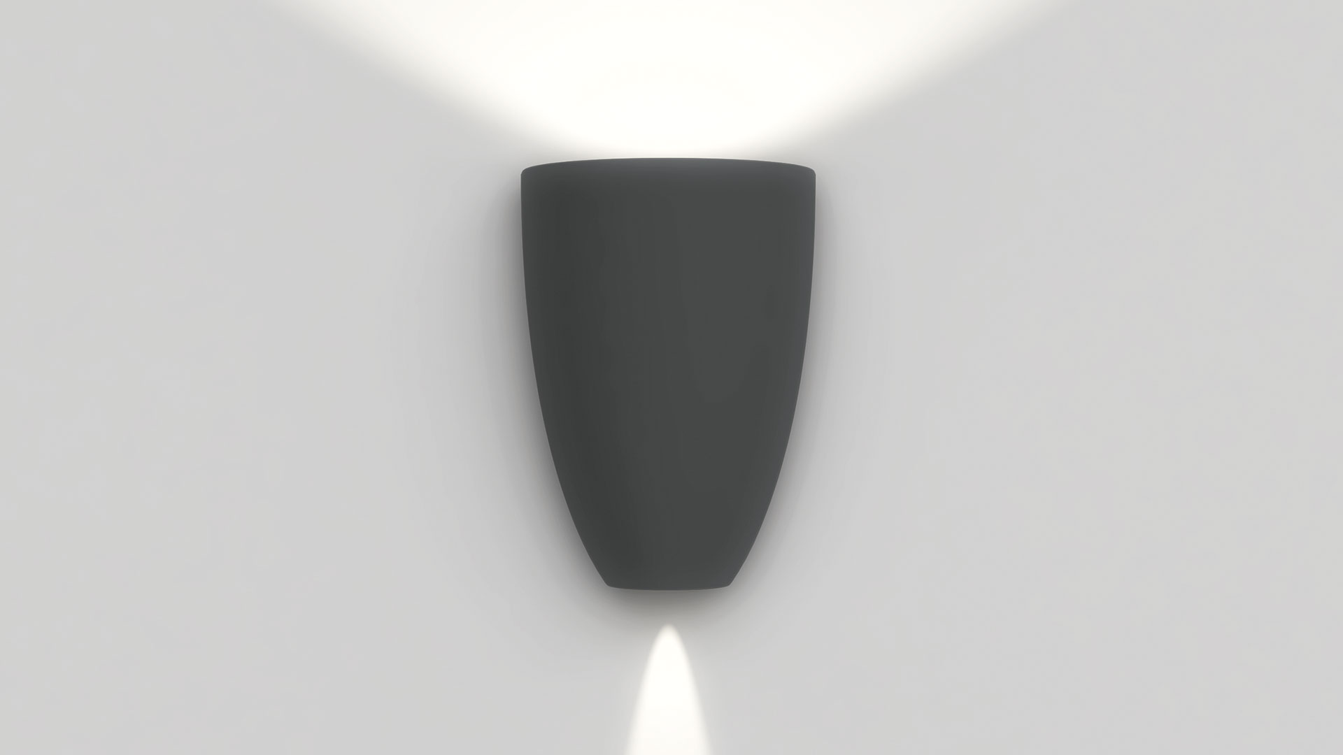 Artemide Molla wall lamp in dark grey, emitting light upward and downward against a white wall