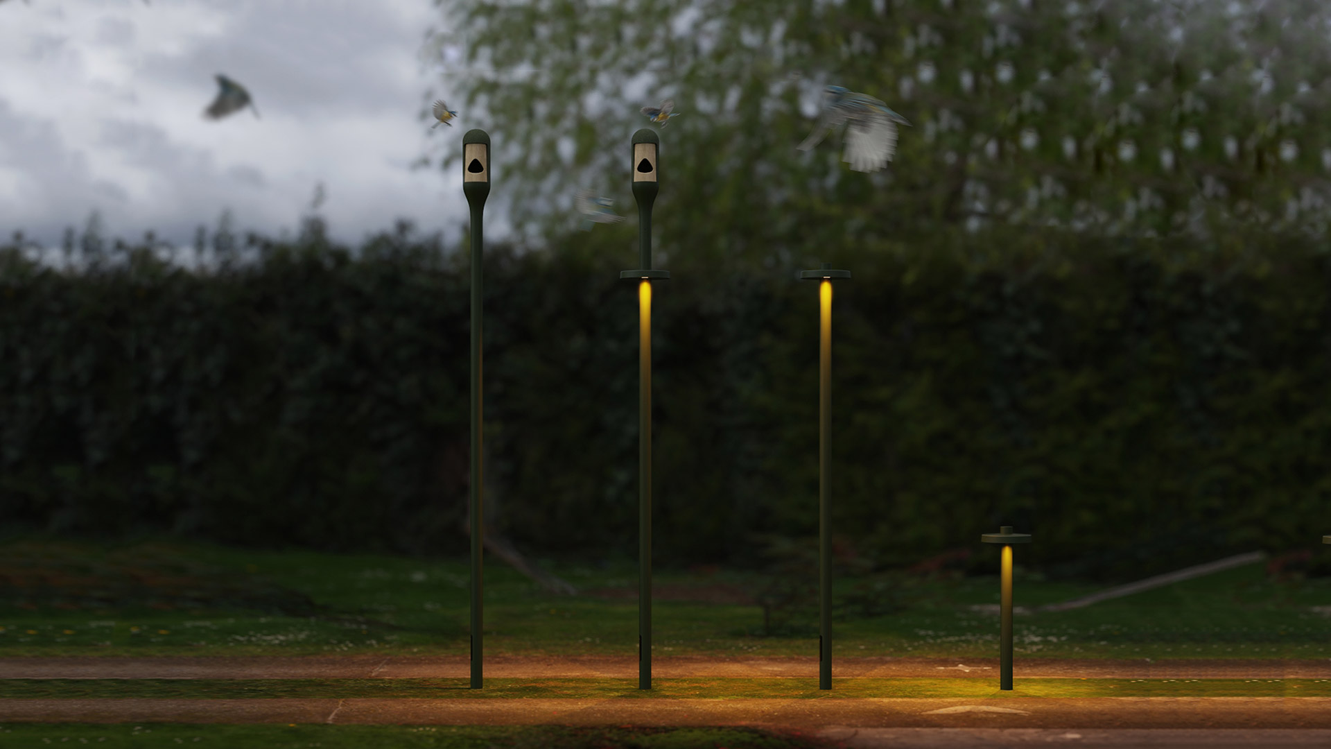 Artemide Needoo outdoor bollard lights in dark green, varying heights, emitting warm yellow light, installed in a park at dusk