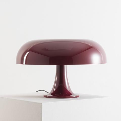Artemide Nesso table lamp in burgundy red, featuring a glossy mushroom-shaped shade on a sculpted pedestal base