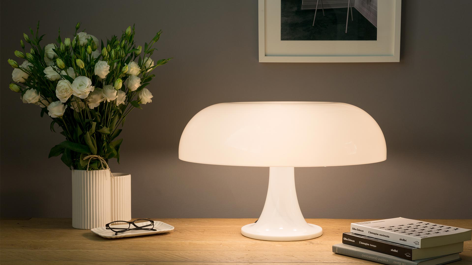 Artemide Nesso table lamp in orange, featuring iconic mushroom-shaped shade on a pedestal base, designed by Giancarlo Mattioli
