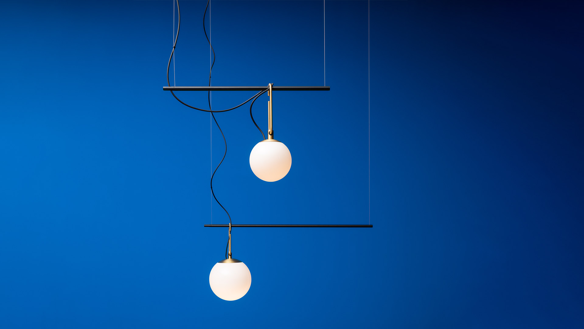 Artemide nh ceiling lamp: oval black metal frame with six opal glass globe pendants at varying heights on black cords