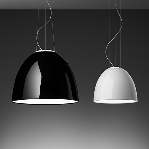 Artemide Nur Gloss pendant lamps: large black glossy dome on left, smaller white glossy dome on right, both suspended by thin cables