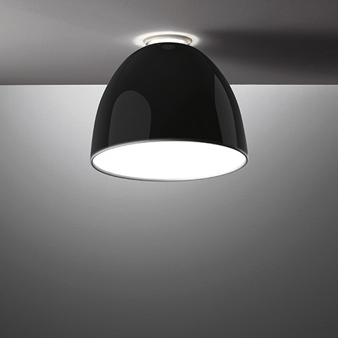 Artemide Nur Mini Gloss ceiling lamp with glossy black dome shade, flush-mounted on ceiling, emitting downward white light