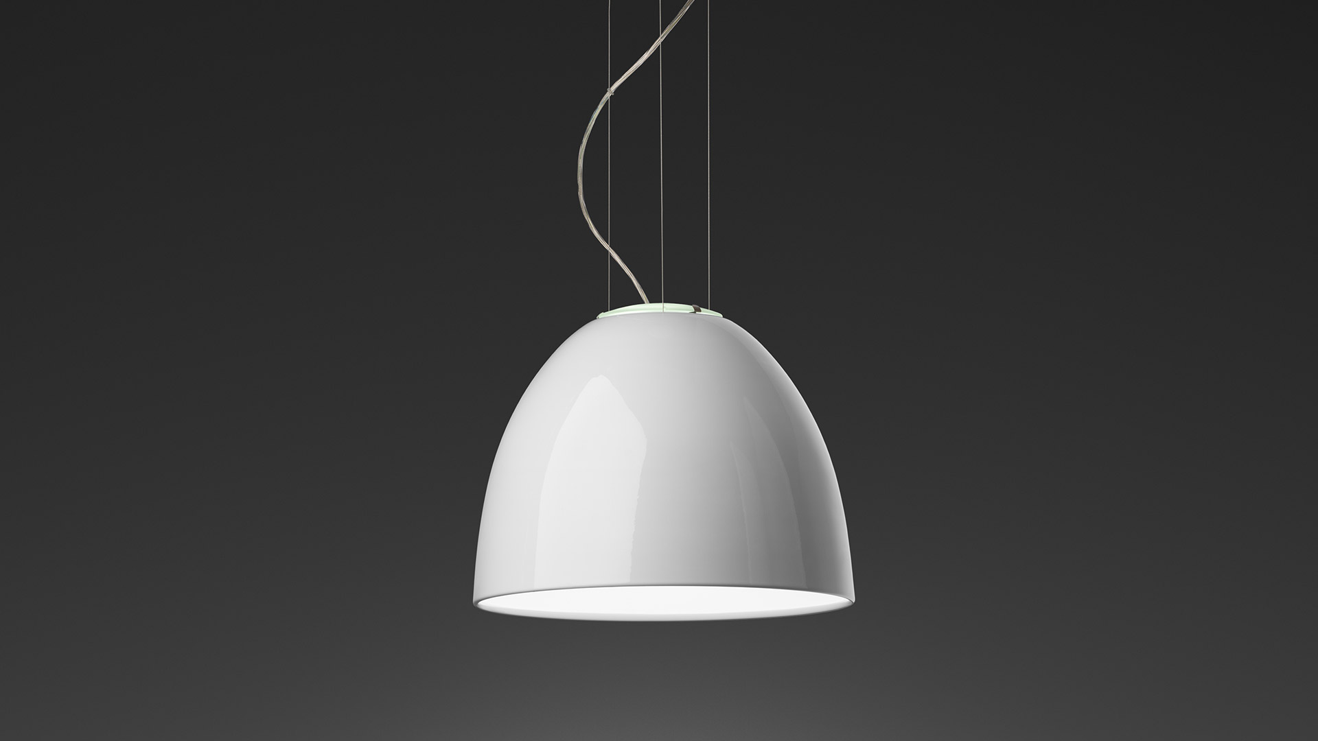 Artemide Nur Mini Gloss pendant lamp with glossy white dome-shaped shade suspended by thin cables on dark background