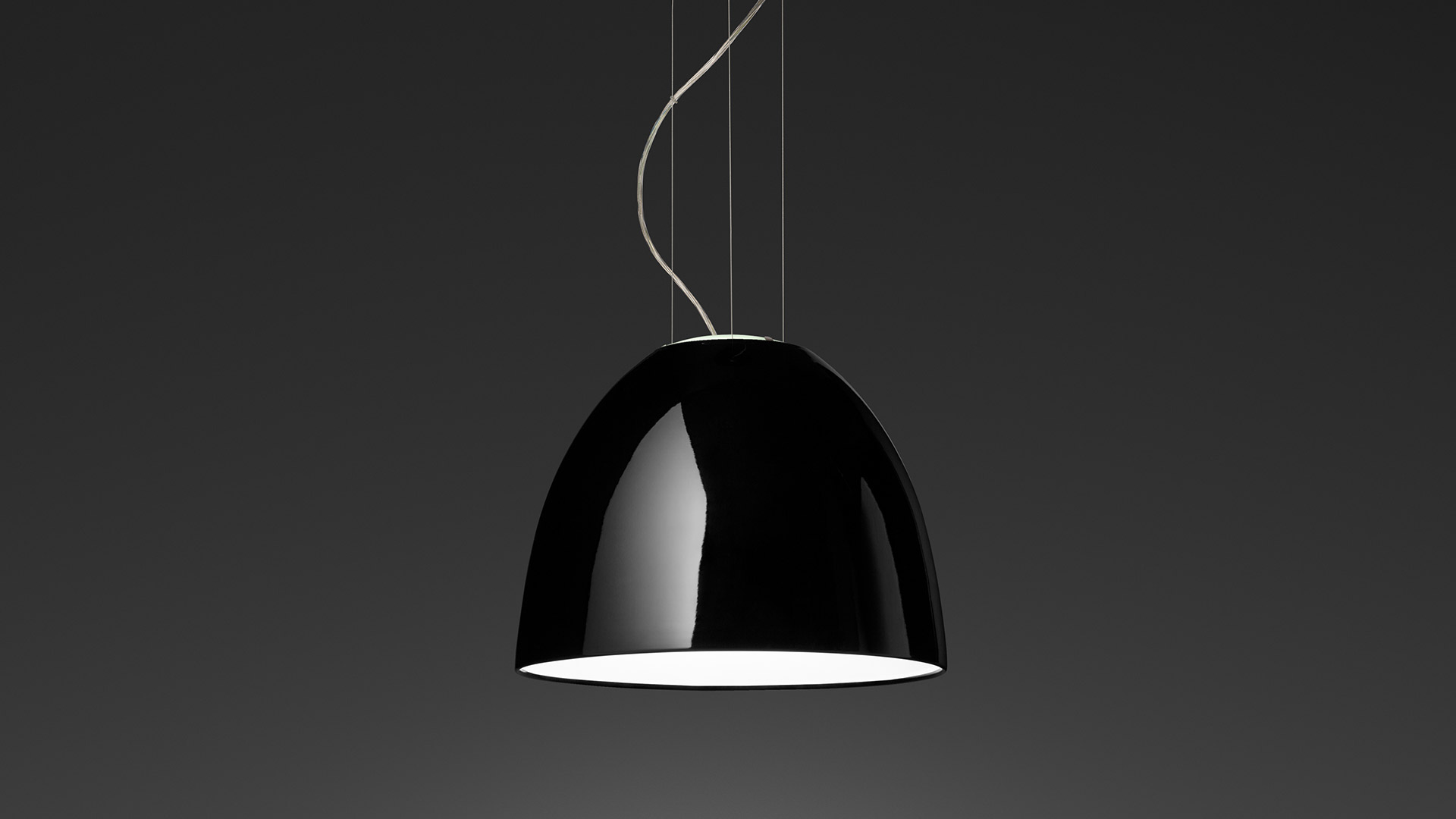 Artemide Nur Mini Gloss pendant lamp with glossy black dome shade and white interior, suspended by thin cables