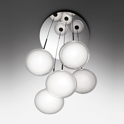 Artemide Orsa Cluster ceiling lamp: six white opal glass disc diffusers suspended on black cables from a circular chrome canopy