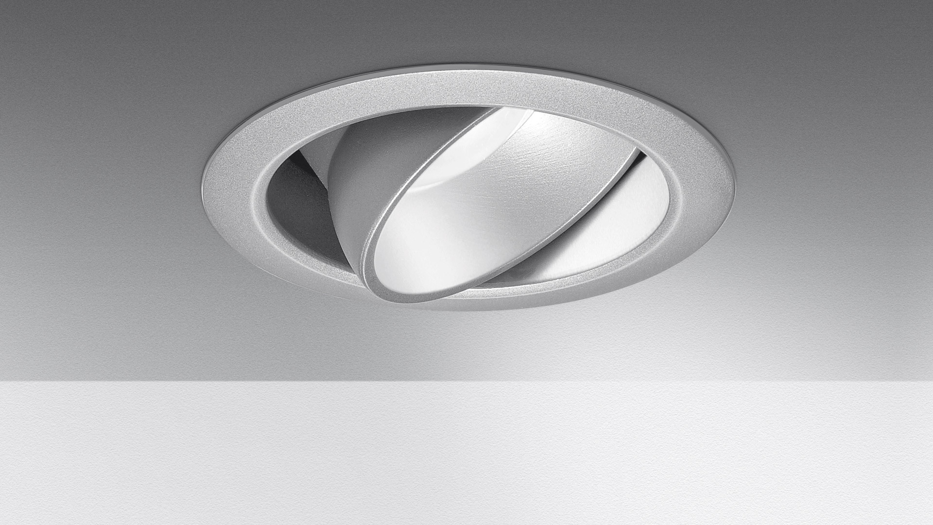 Artemide Parabola 80 recessed ceiling spotlight in silver, featuring a tilting parabolic reflector for adjustable directional lighting