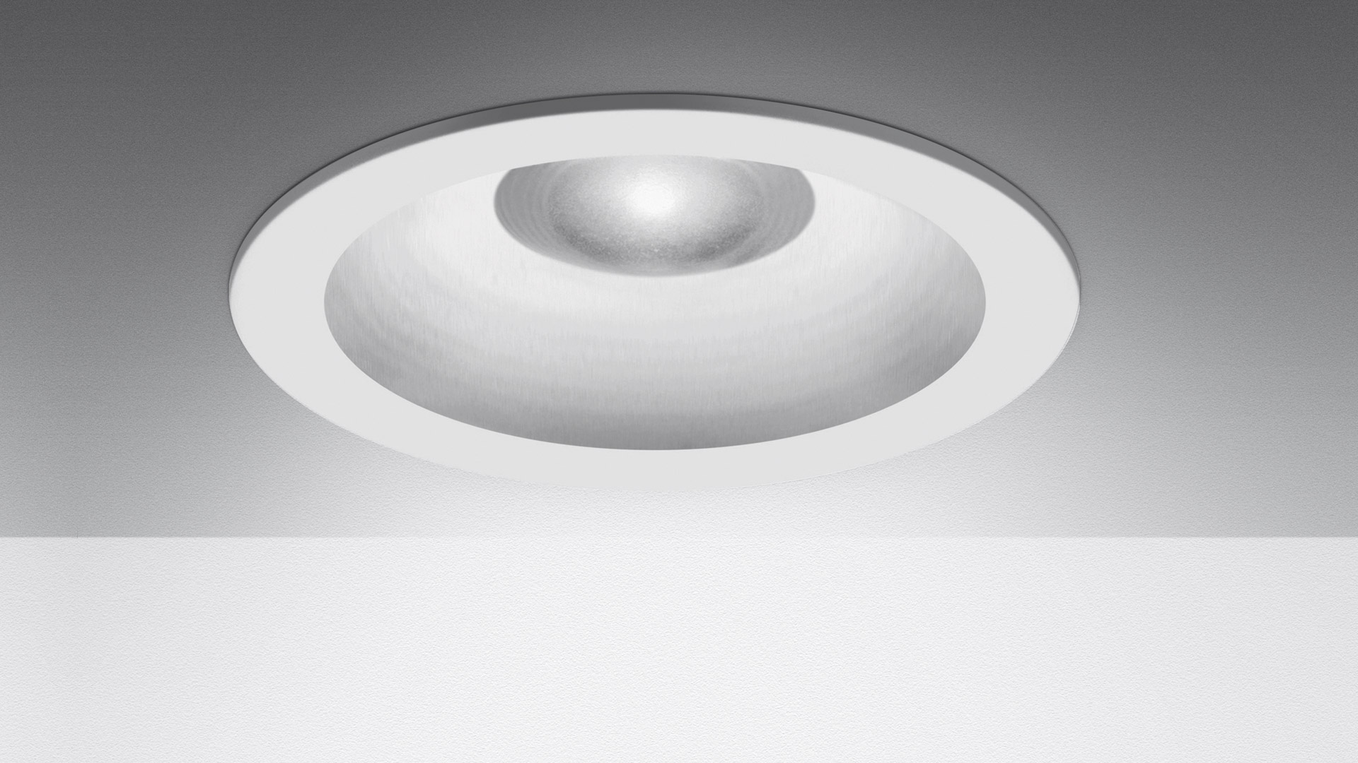 Artemide Parabola 100 recessed ceiling downlight with white circular trim and deep parabolic reflector housing LED source