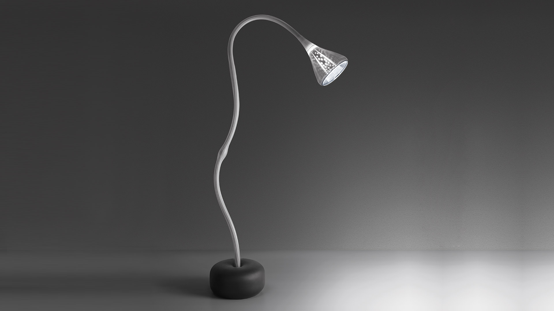 Artemide Pipe Floor lamp: sleek flexible silver gooseneck stem on round black base, conical LED head casting focused downward light