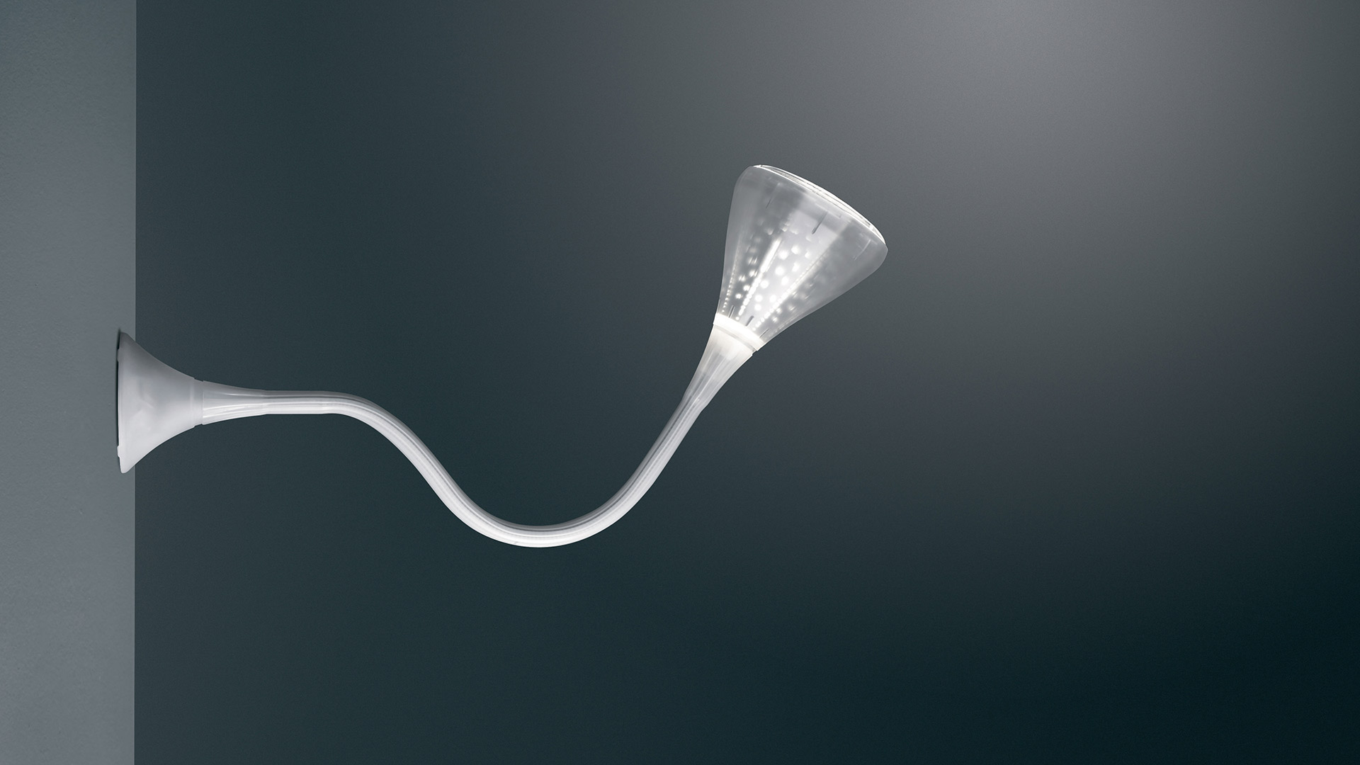 Artemide Pipe wall lamp with flexible white stem and flared trumpet-shaped LED diffuser, mounted on a dark wall
