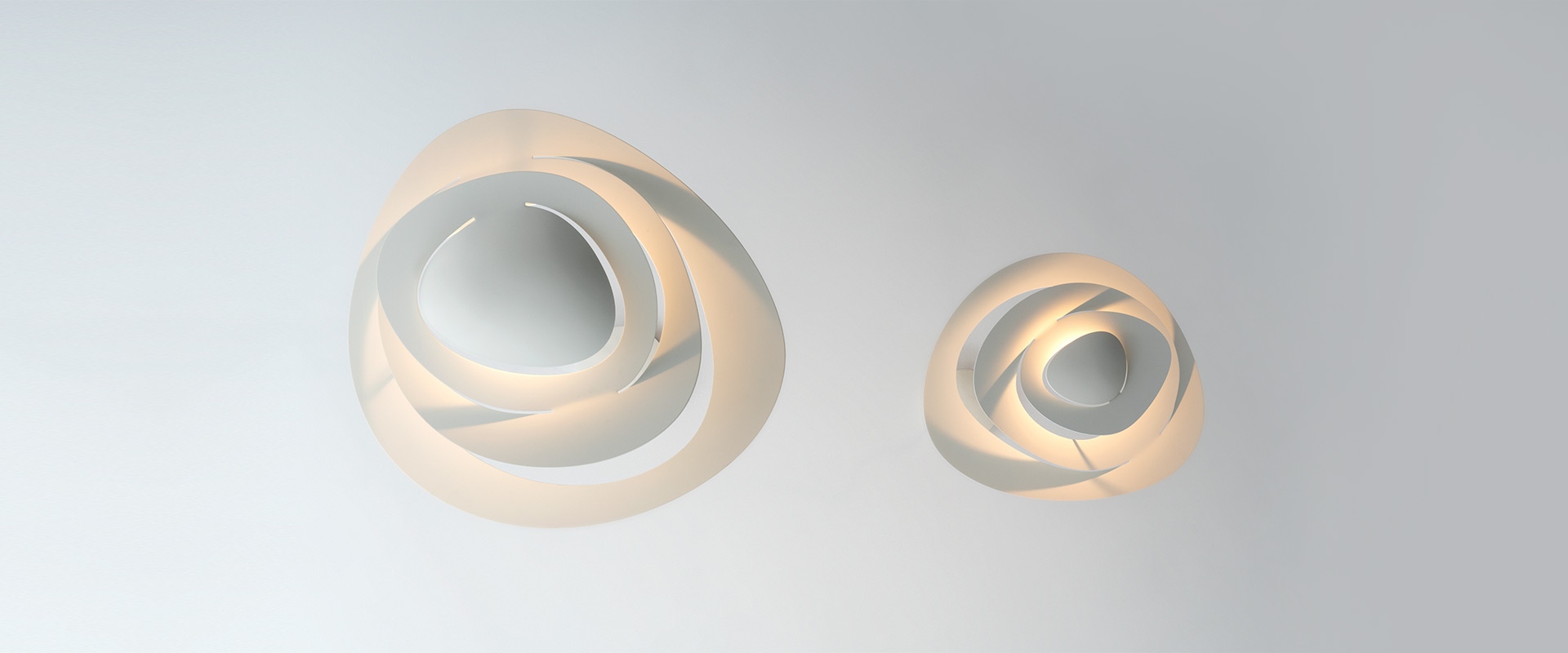 Artemide Pirce pendant lamp in gold, featuring an elegant spiral ribbon-shaped diffuser suspended by thin cables