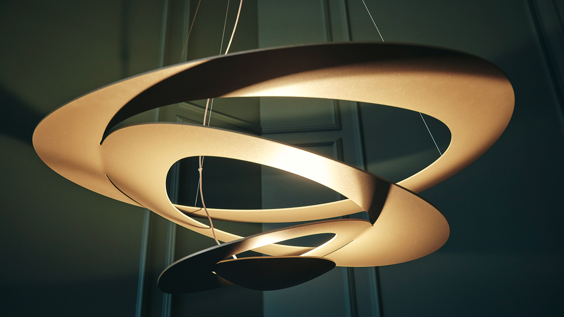 Two Artemide Pirce suspension lamps in white, featuring organic swirling spiral shades in large and small sizes