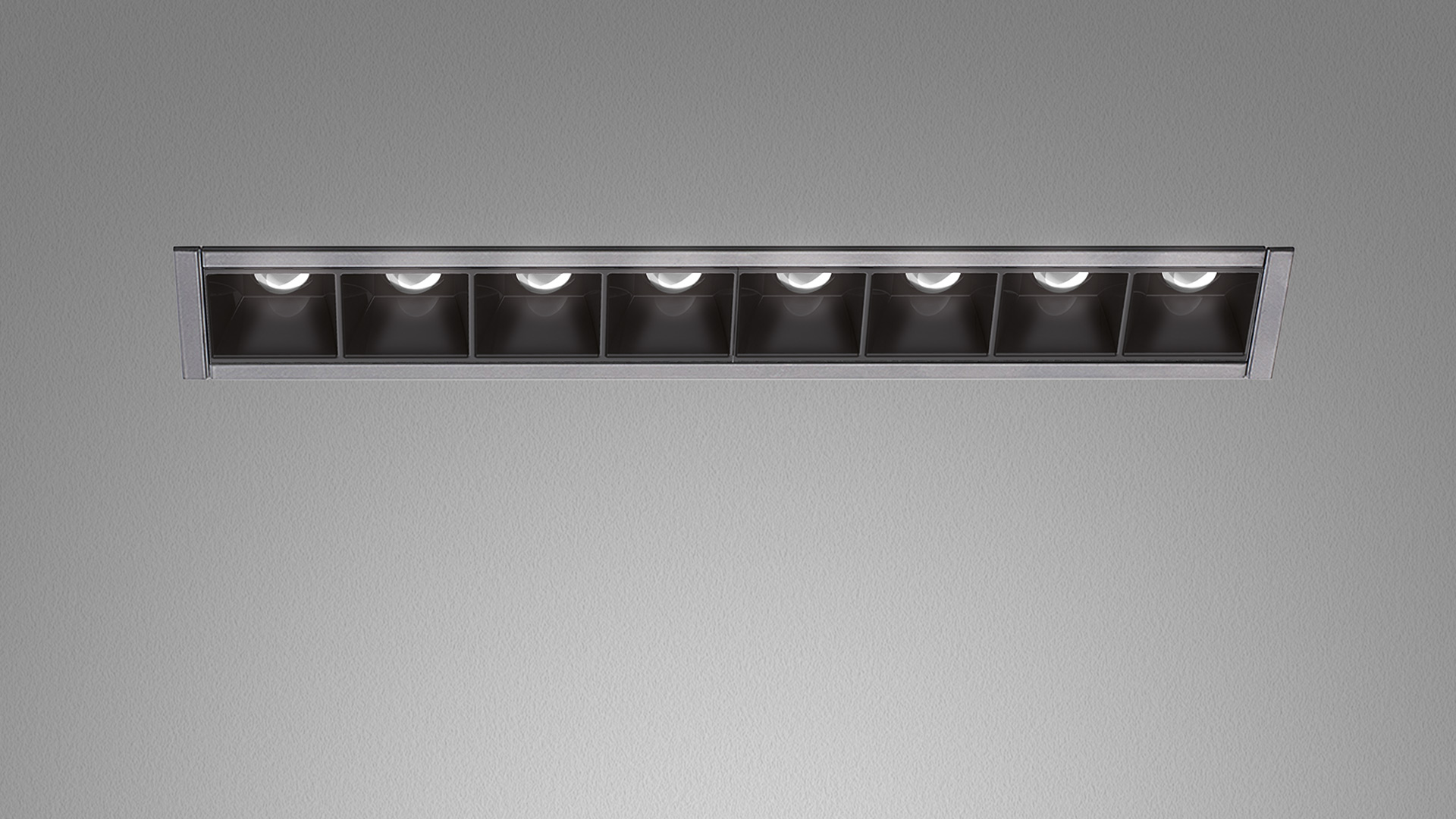 Artemide Sharp Refractive Emission: recessed linear ceiling fixture with 8 black square cells and LED light sources in silver frame
