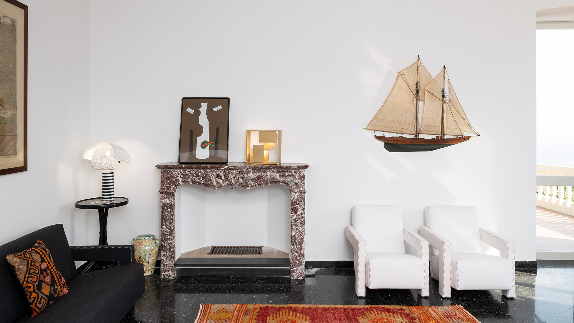Artemide Shogun table lamp with adjustable white ribbed shade and black-and-white striped cylindrical base on white pedestal