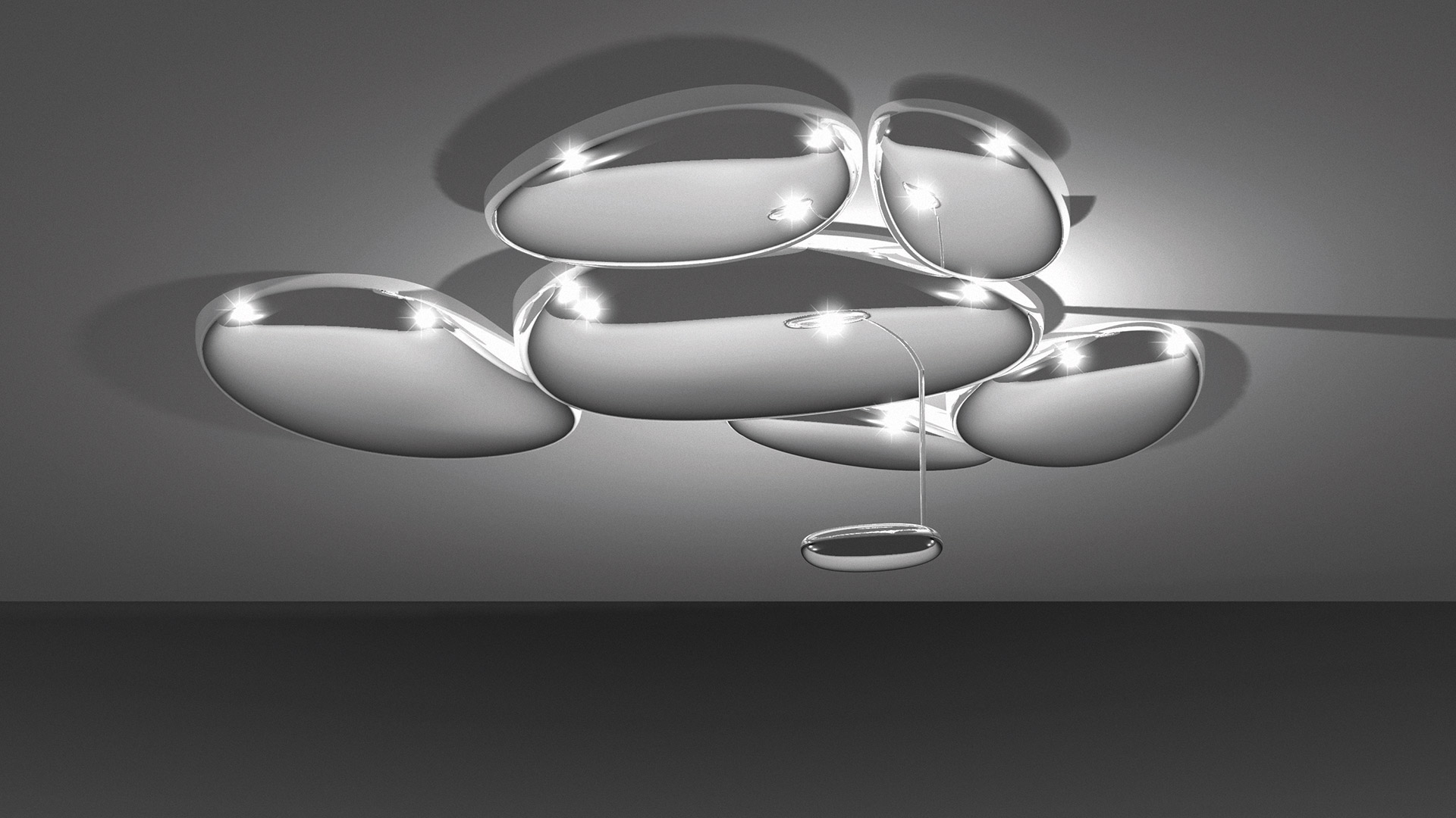 Artemide Skydro ceiling lamp: cluster of polished chrome oval modules on ceiling with a small pendant ring below