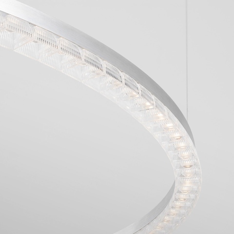 Artemide Somnĭum pendant lamp: close-up of circular aluminum ring with crystal glass LED modules emitting warm white light