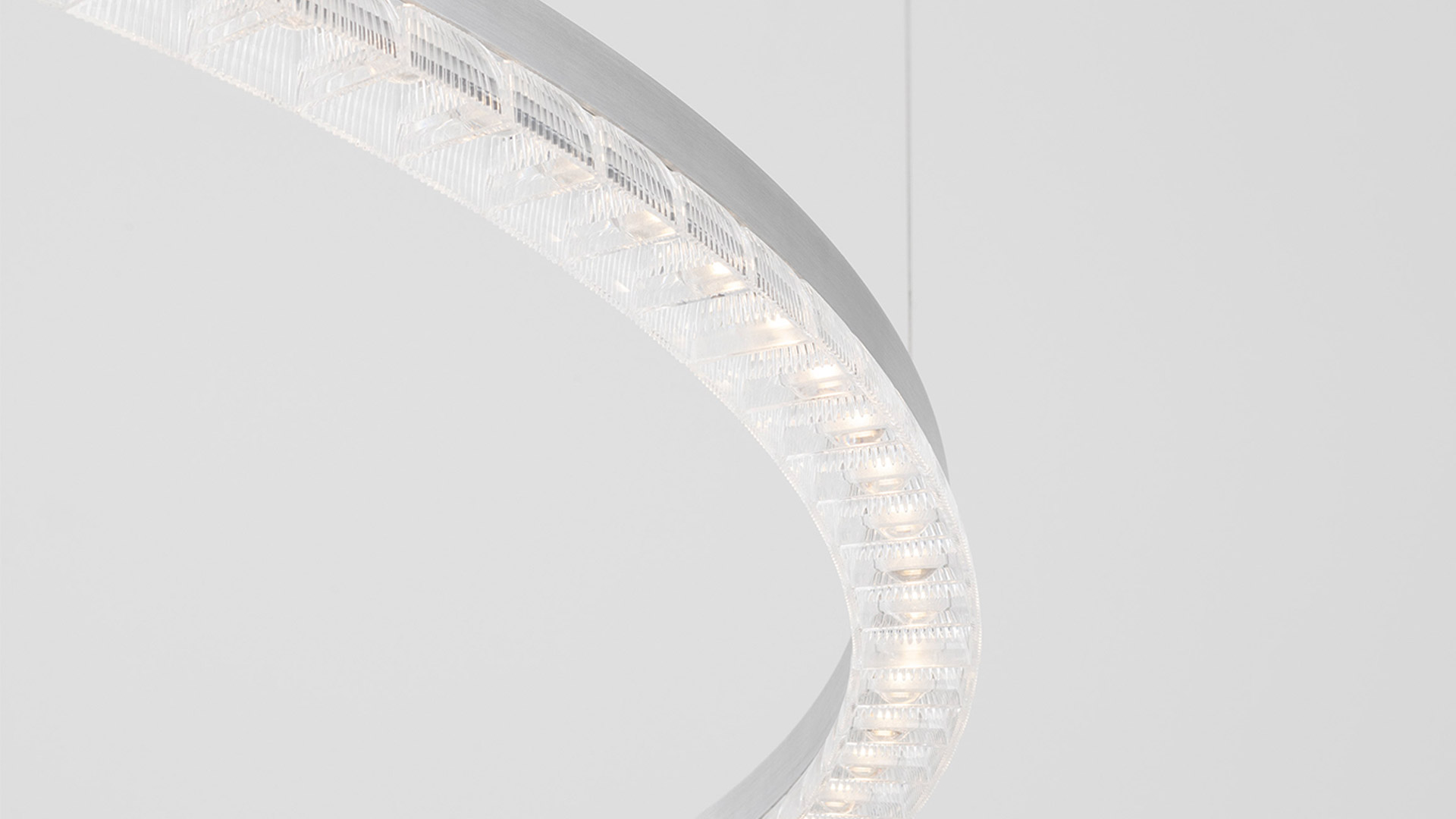 Artemide Somnĭum System: two intersecting transparent linear light bars with geometric prismatic diffusers surrounded by dramatic smoke