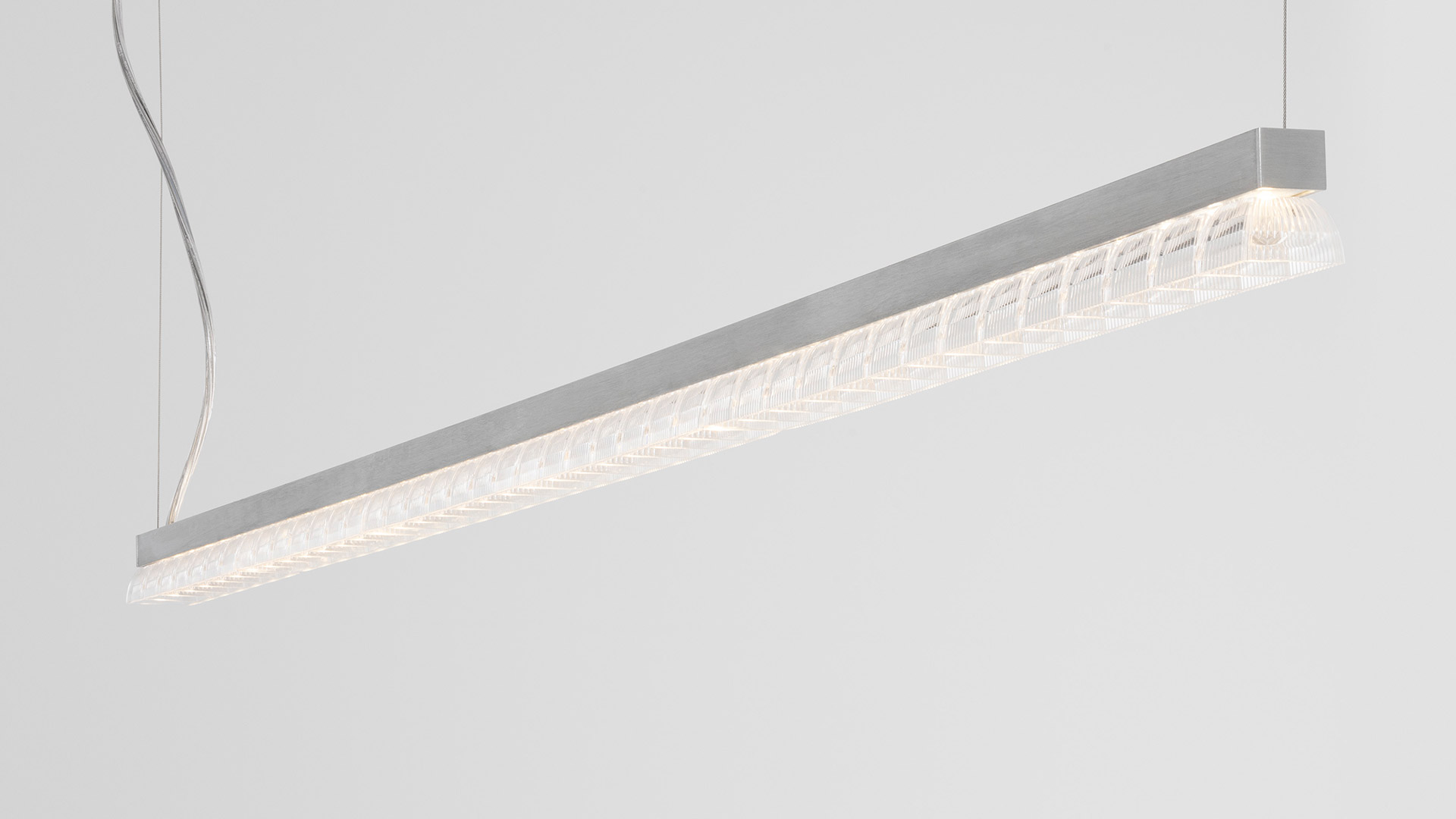 Artemide Somnĭum Stand Alone: slim linear LED pendant lamp in silver aluminum with decorative lattice diffuser, suspended by thin cables