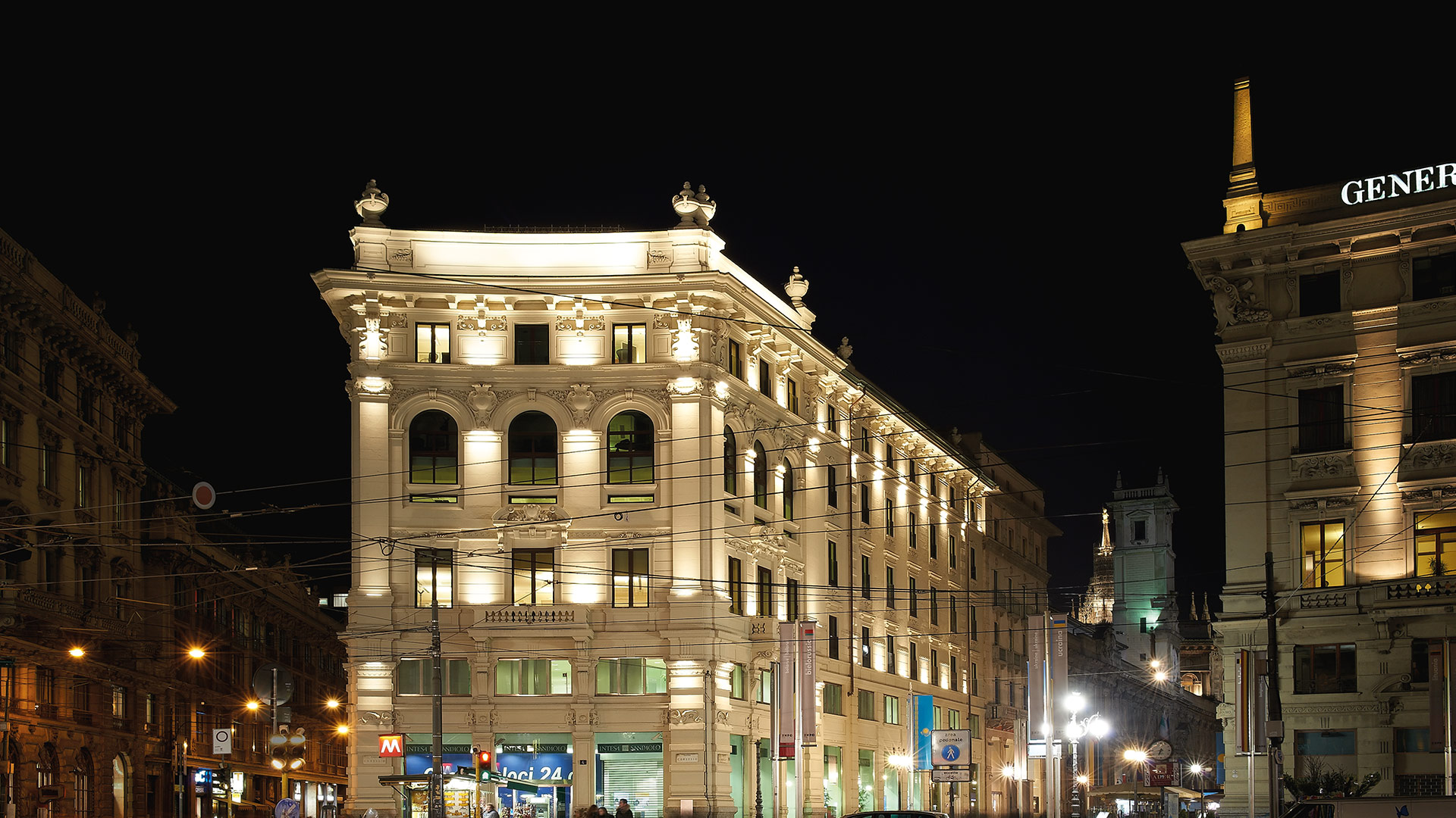 Historic neoclassical building in Milan illuminated at night by Artemide Spike outdoor spotlights highlighting its ornate facade