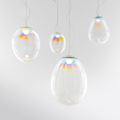 Four Artemide Stellar Nebula pendant lamps: transparent iridescent glass bubbles in varying oval shapes, emitting colorful rainbow reflections