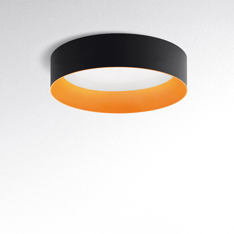 Tagora Soffitto 970 ceiling lamp by Artemide: round black exterior ring with warm orange interior, diffused white LED light