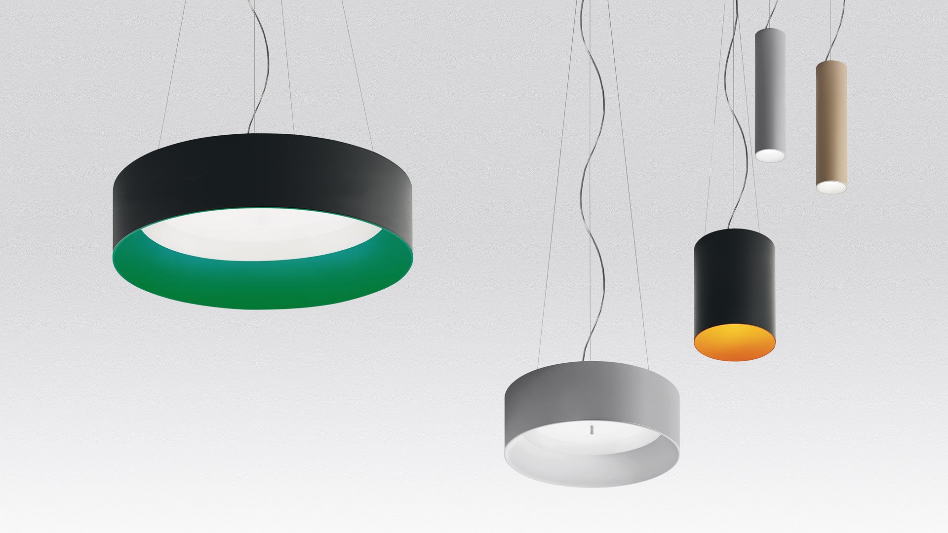 Artemide Tagora Sospensione 570: five pendant lights featuring ring and cylinder shapes in black, grey, and tan with green and gold inner accents