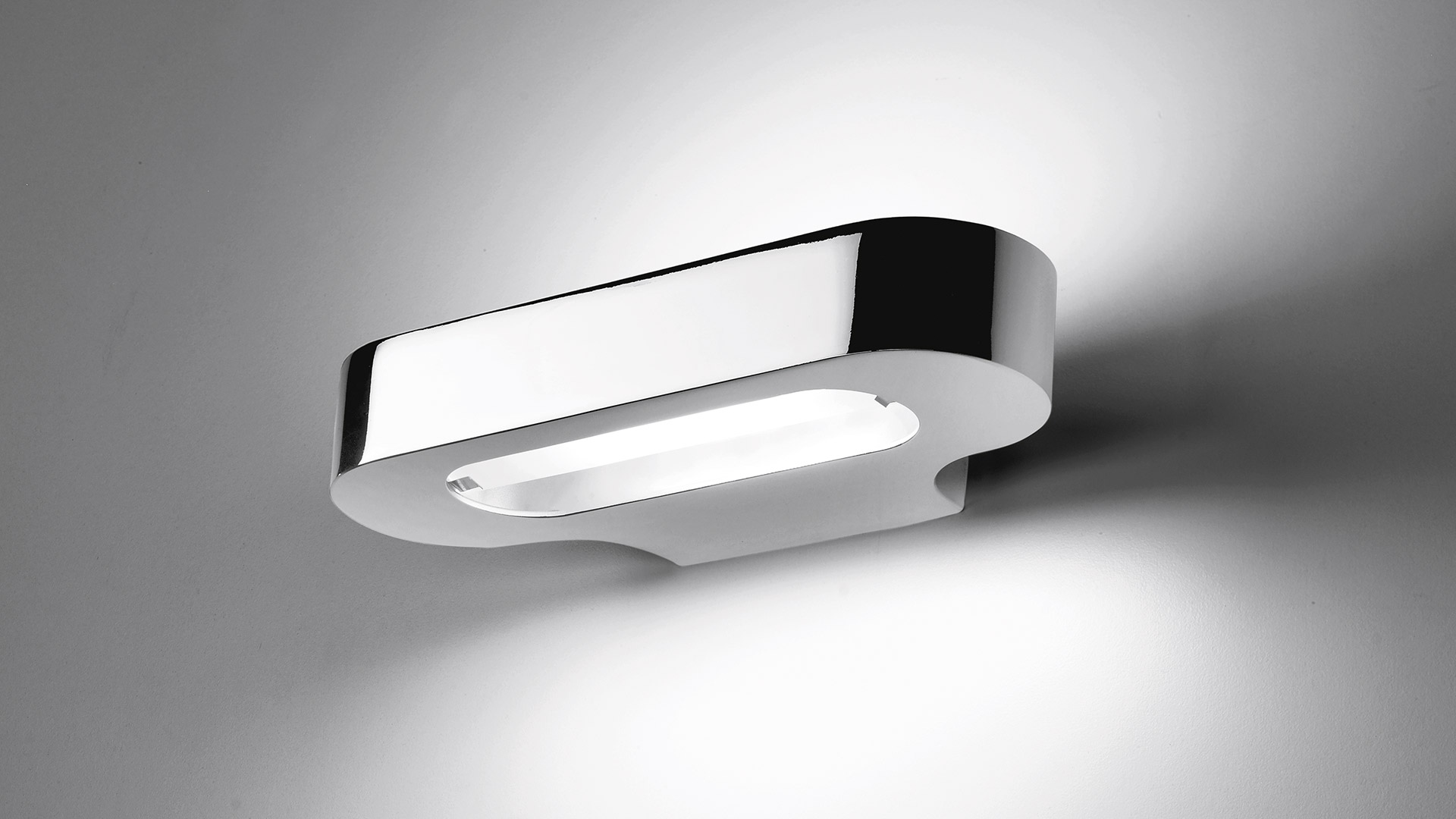 Artemide Talo wall lamp in chrome finish, oval-shaped body emitting diffused white light from both sides