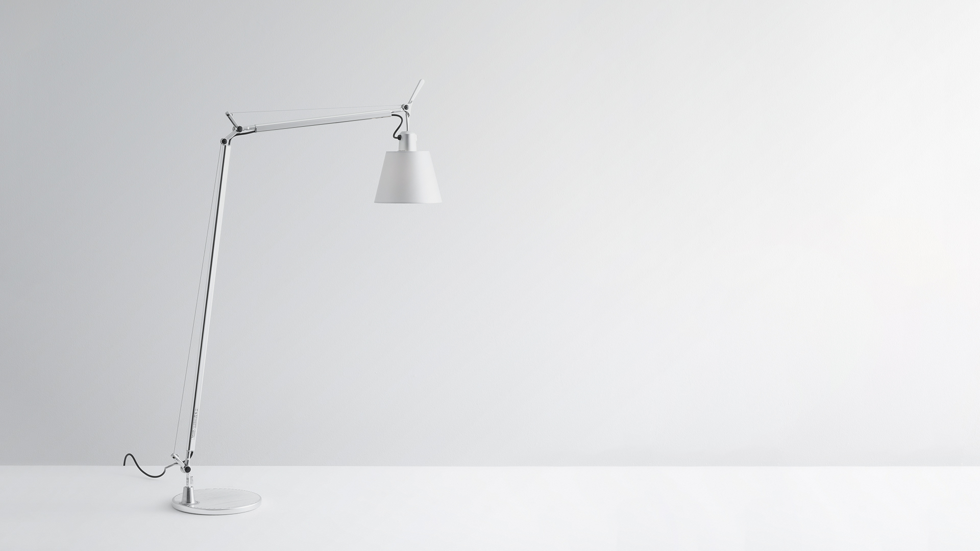 Artemide Tolomeo Basculante Reading Floor lamp in white, featuring adjustable articulated arm and conical shade on circular base