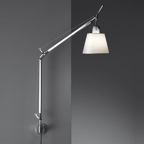Artemide Tolomeo Parete wall lamp with adjustable aluminum arm and white conical shade, mounted on a grey wall