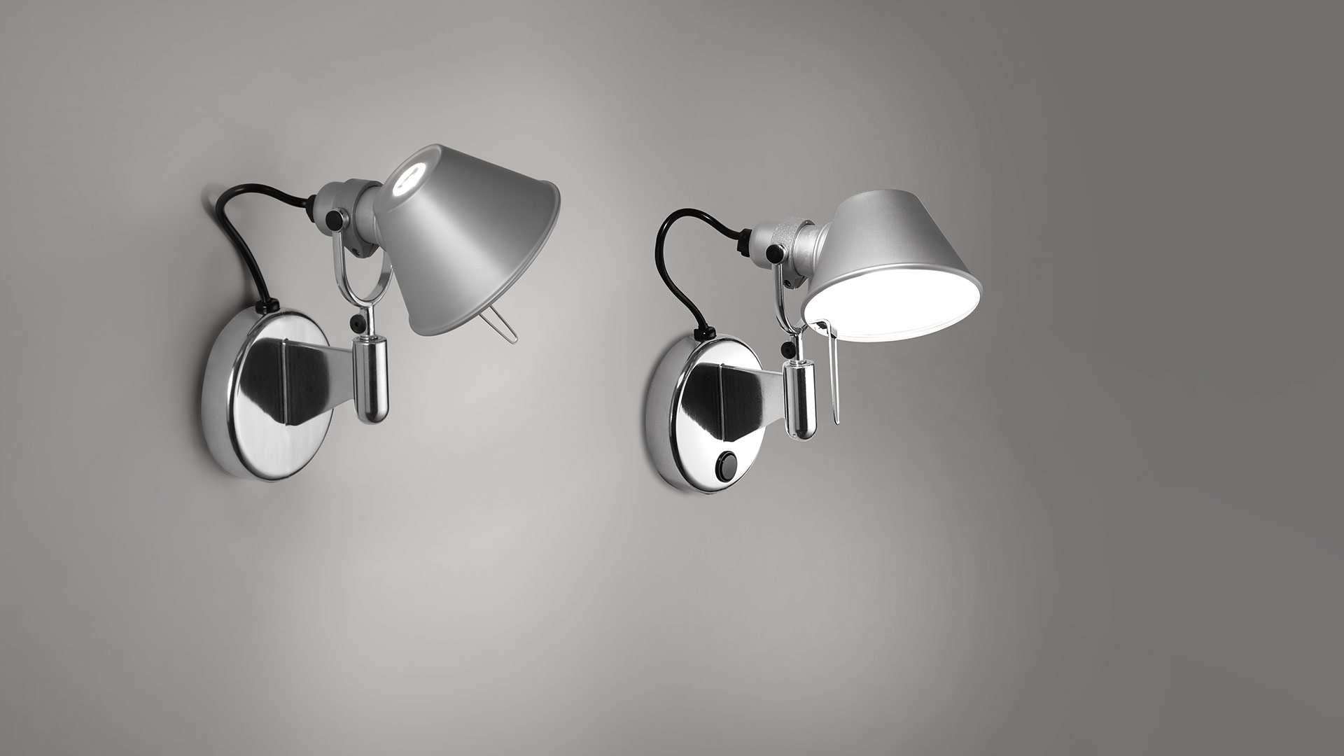 Two Artemide Tolomeo Micro Faretto wall lamps in aluminum, adjustable conical shades on chrome wall mounts, shown off and on