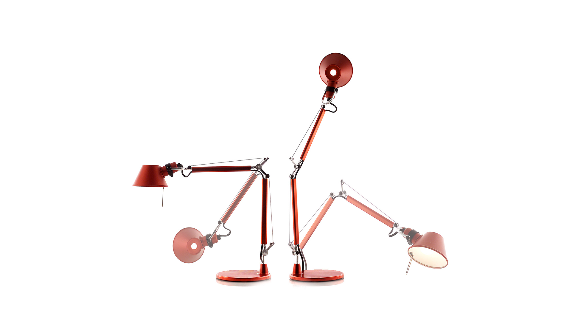 Artemide Tolomeo table lamp displayed on a red stage with arched backdrop and dramatic red curtains, monochromatic theatrical setting