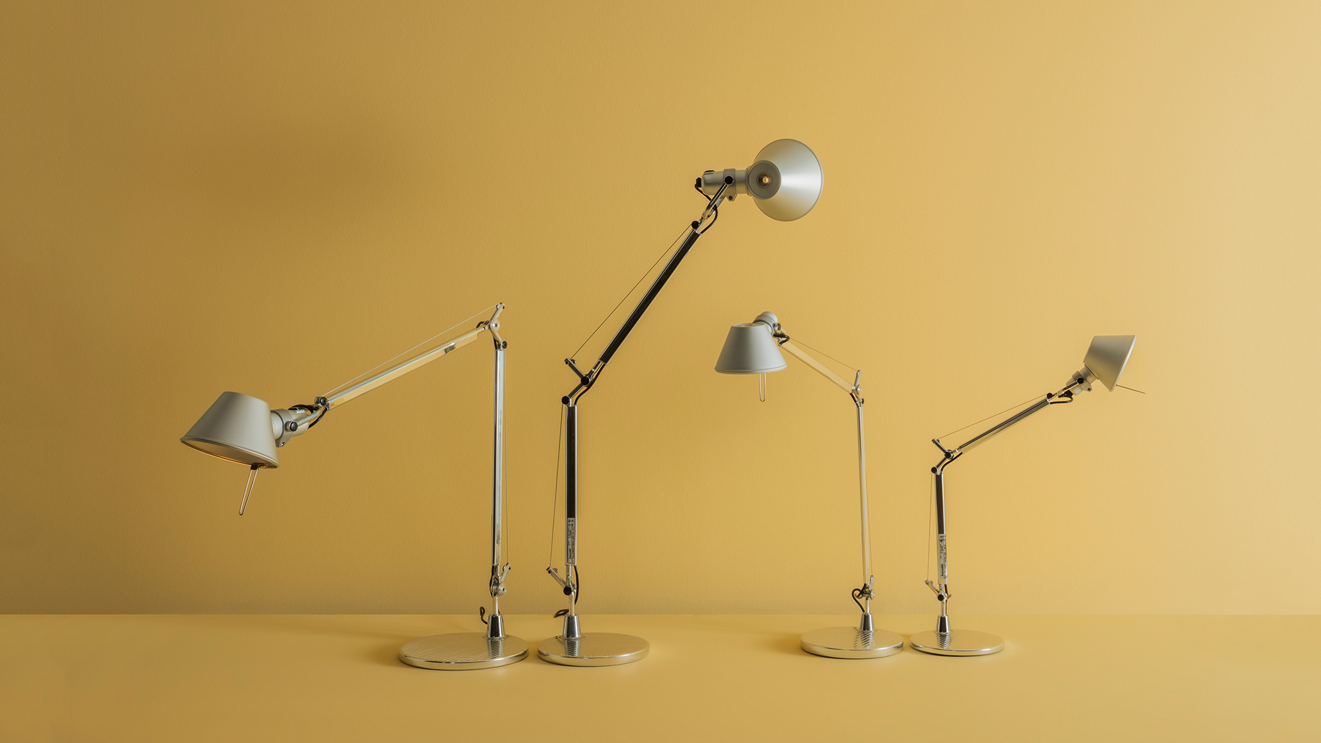 Artemide Tolomeo Tavolo lamp head detail: polished aluminum conical shade with central LED lens and adjustable joint mechanism