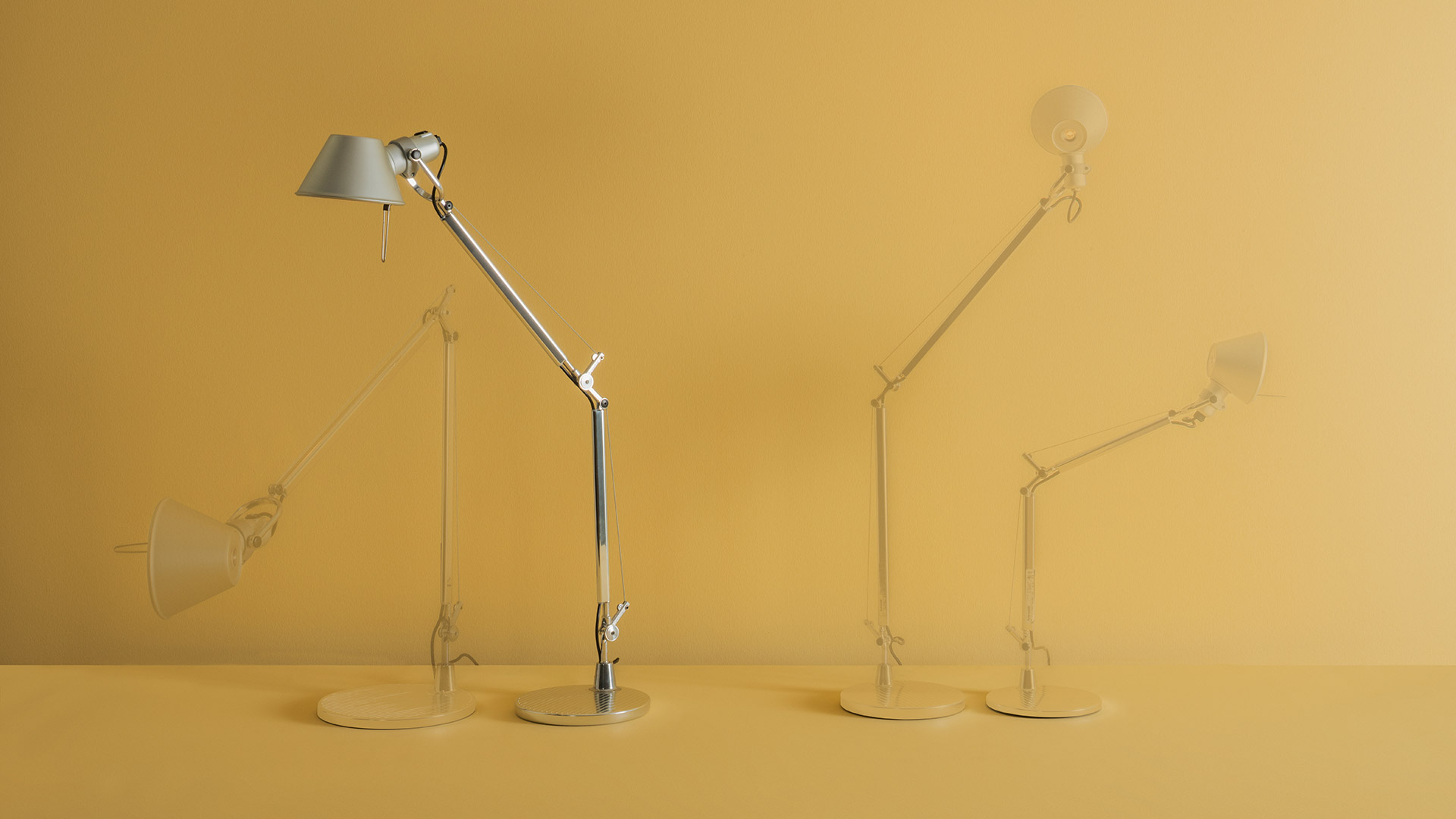 Artemide Tolomeo Mini Tavolo desk lamp in polished aluminium with adjustable double-arm and conical shade on circular base