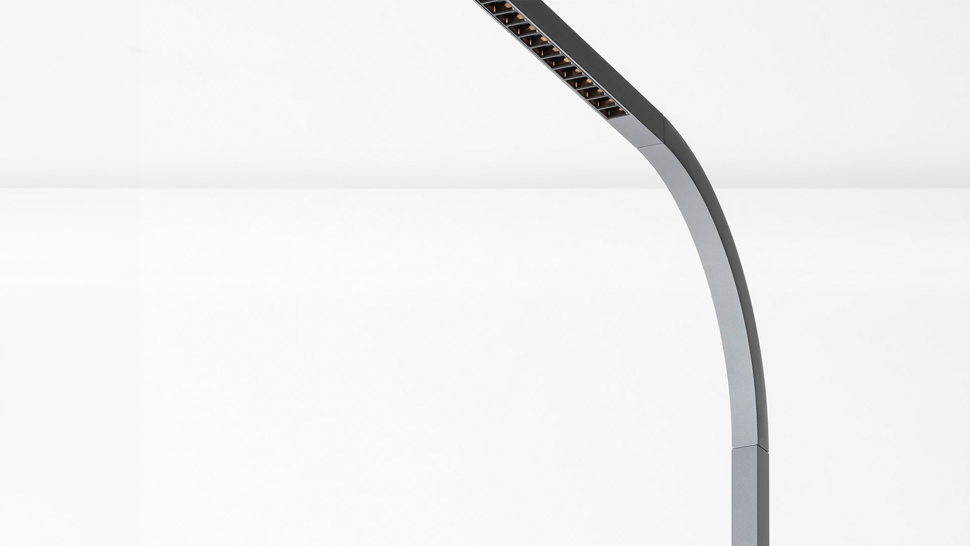 Artemide Turn Around Floor lamp: sleek curved stem in dark aluminum with LED light head featuring micro-lens optics
