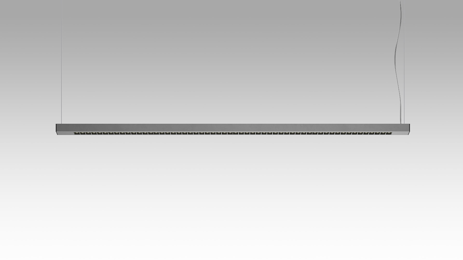 Artemide Turn Around Suspension: slim horizontal LED bar in dark grey, suspended by two cables, with directional light modules along its length