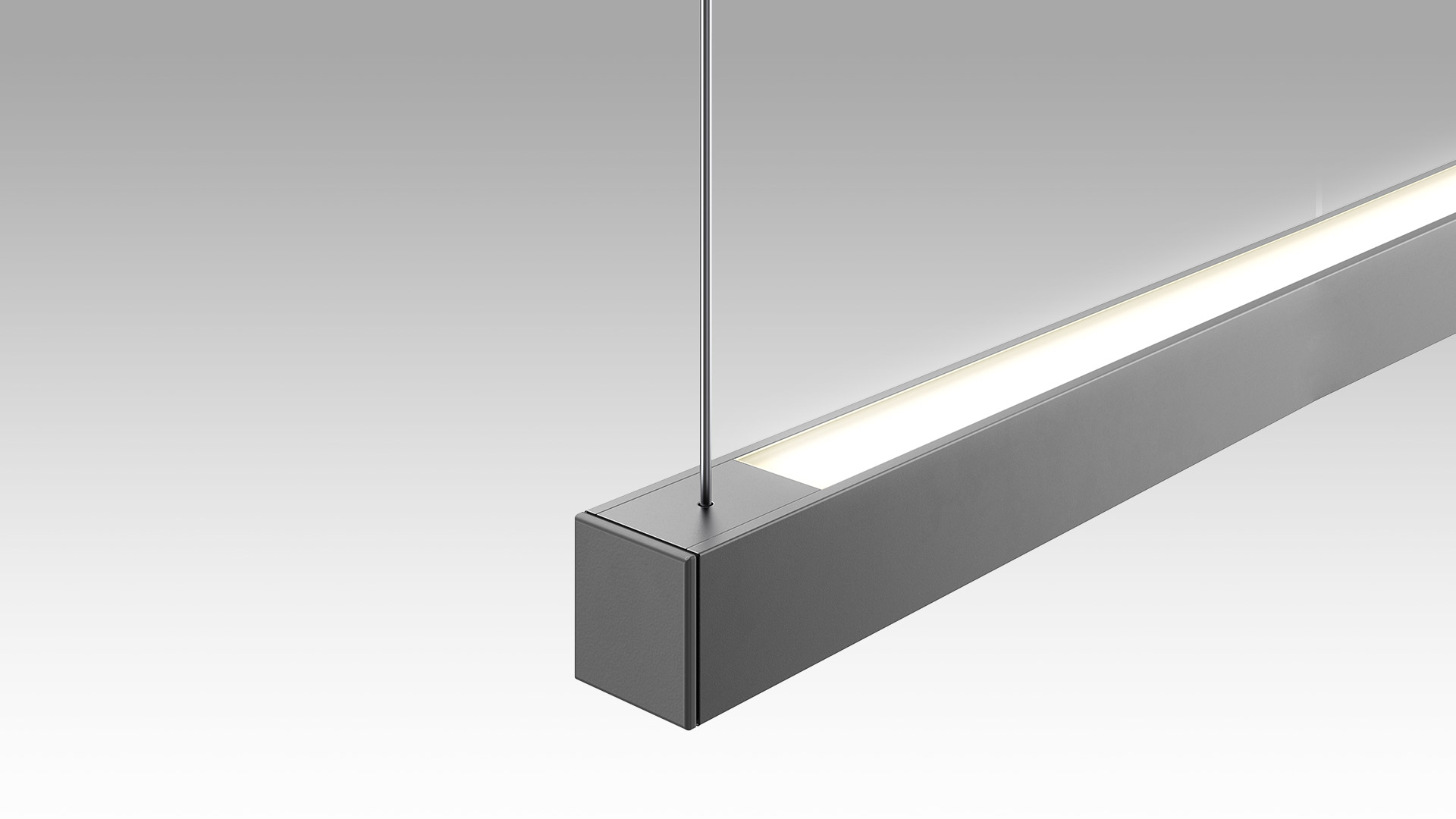 Turn Around Suspension by Artemide: sleek dark grey rectangular LED linear pendant light with frosted diffuser, suspended by steel cable