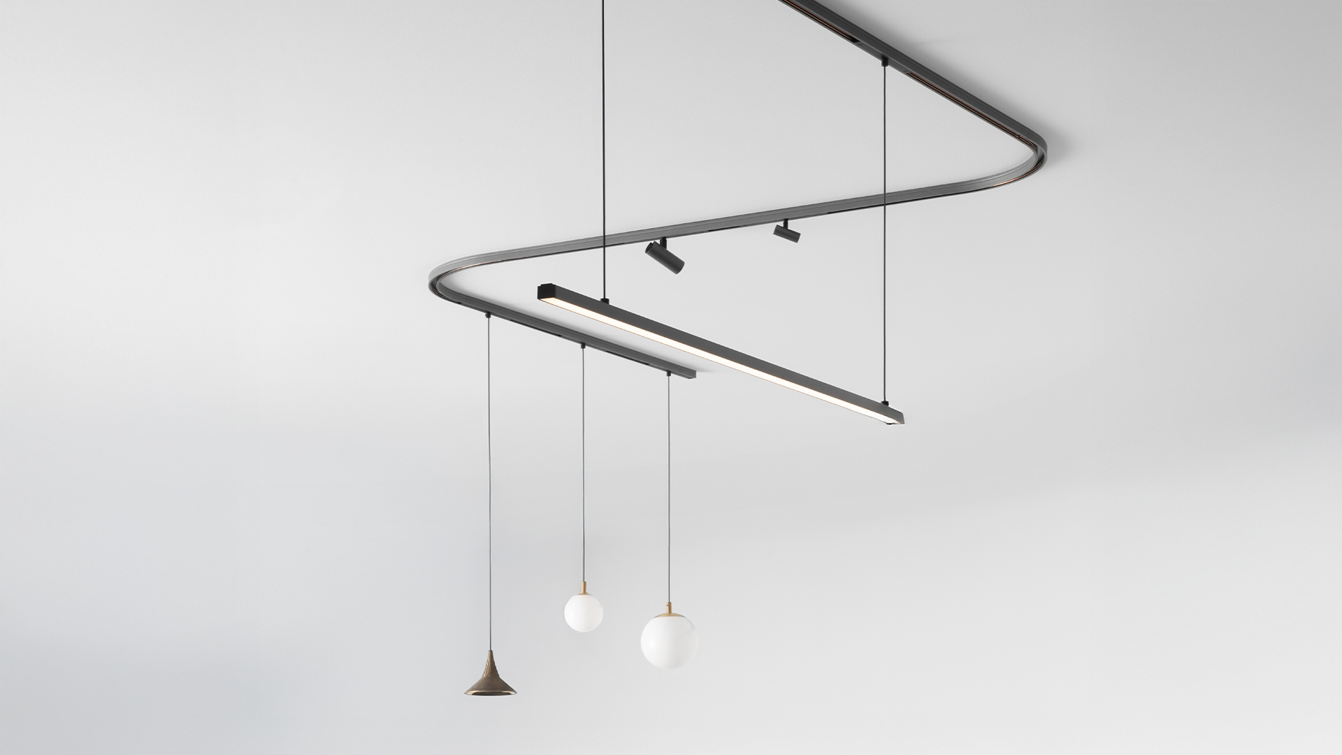 Artemide Turn Around System: curved linear LED track light in silver and black, featuring adjustable directional LED modules along a sleek rail