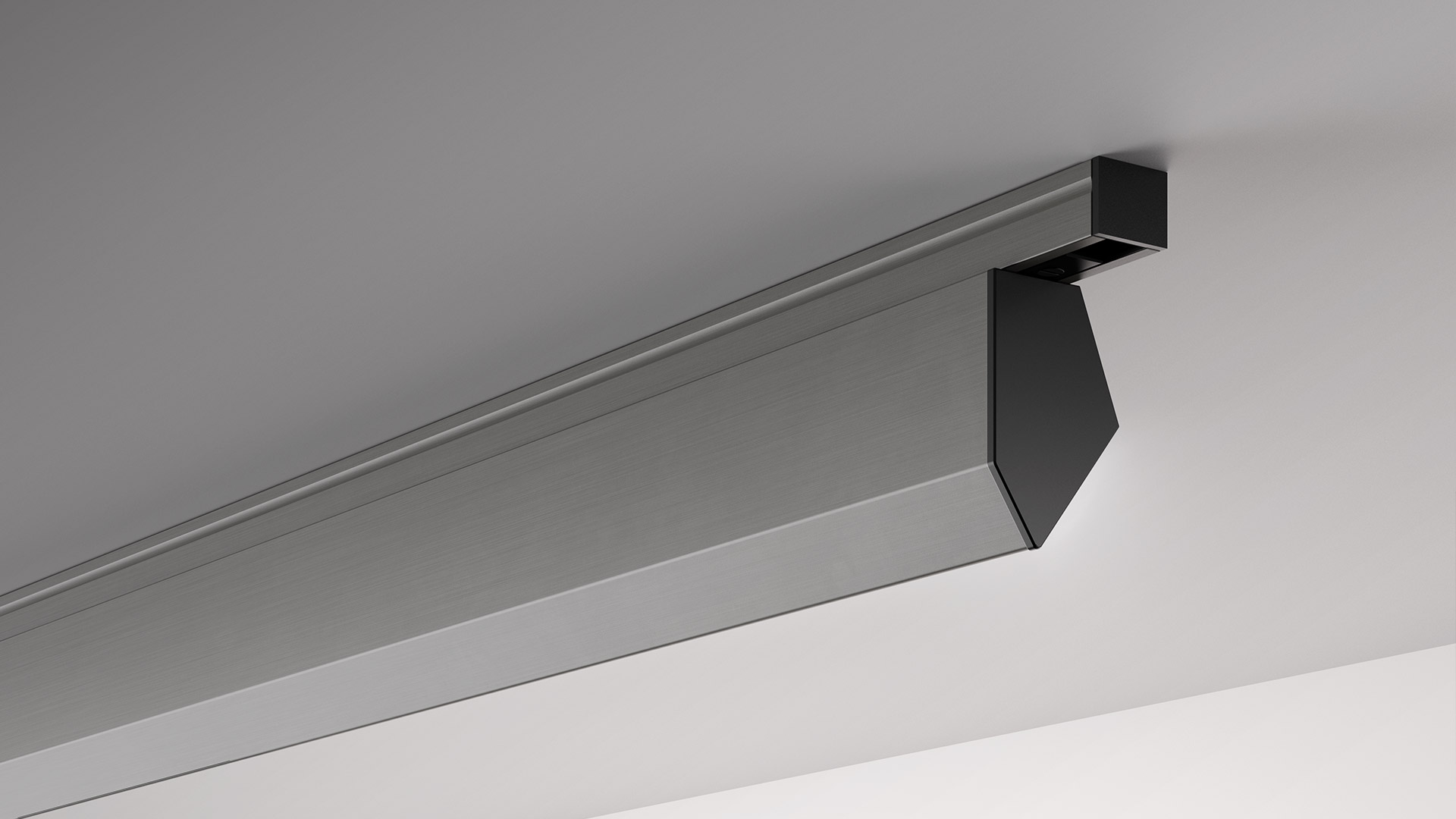 Artemide ceiling-mounted linear light fixture in brushed aluminum with a black angular end cap, installed along a wall-ceiling junction.