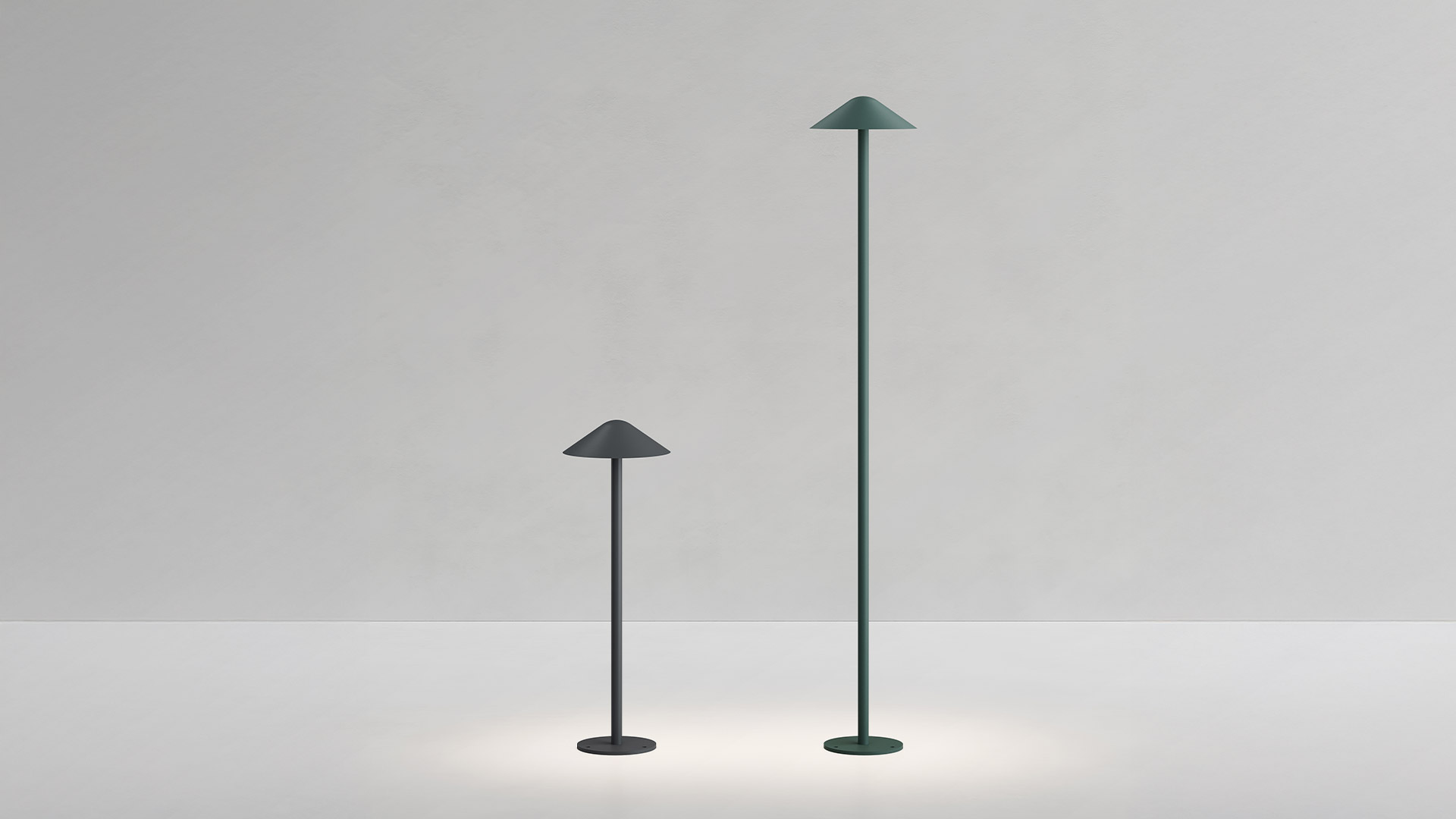 Artemide Vea Bollard outdoor lamp: dark green pole topped with a wide conical shade emitting warm white downward light