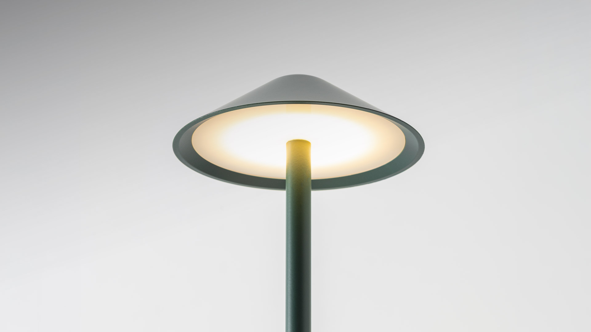 Artemide Vea Bollard outdoor lamp in sage green, featuring a wide conical shade atop a slender cylindrical stem