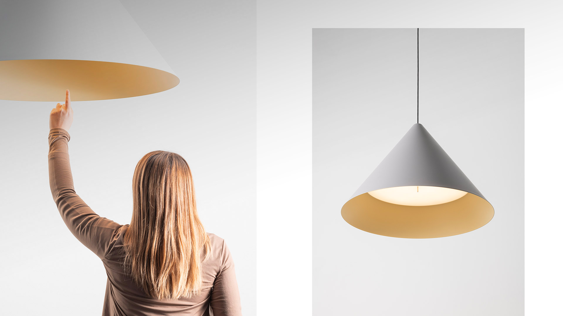 Close-up of Vea suspension lamp by Artemide: conical shade with white exterior and warm golden-yellow interior finish