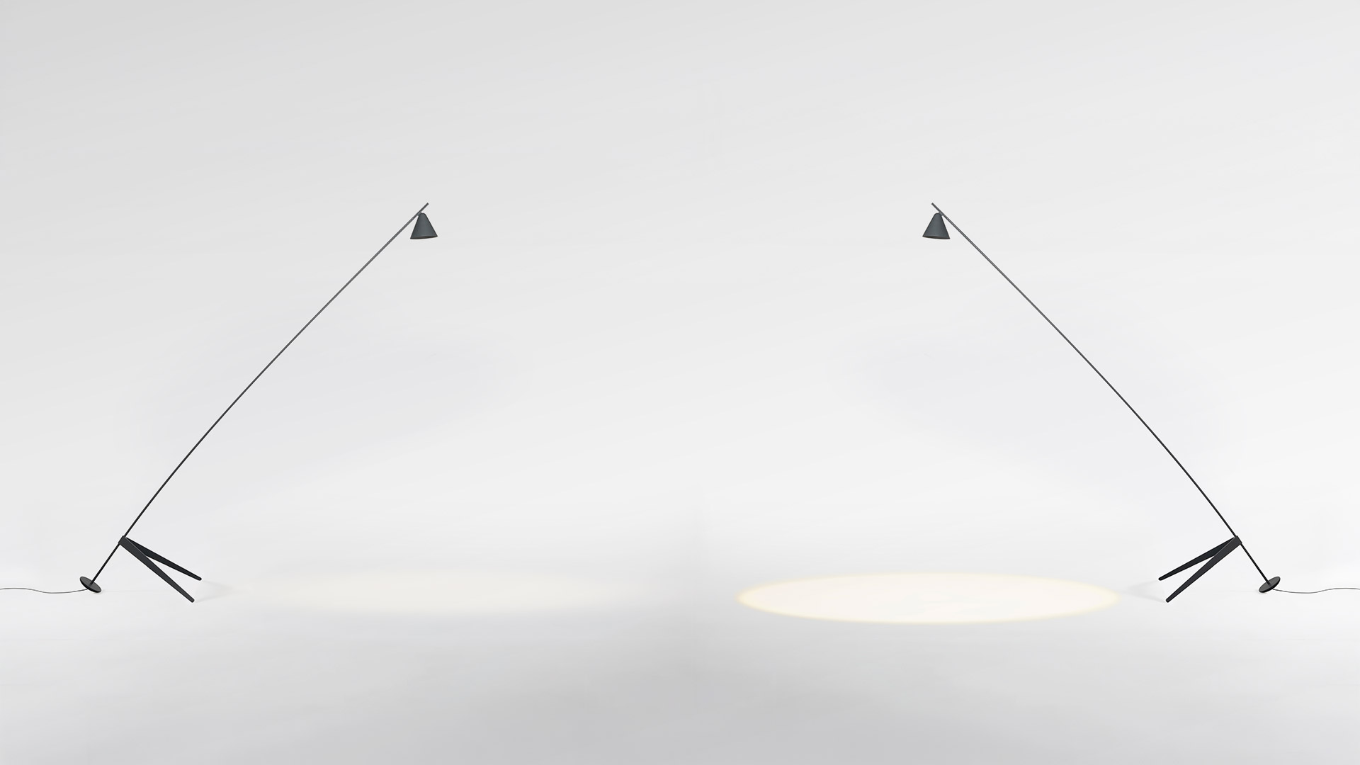 Artemide Vea outdoor floor lamp on a terrace at dusk, slim dark pole with round head, beside an olive tree and Mediterranean garden