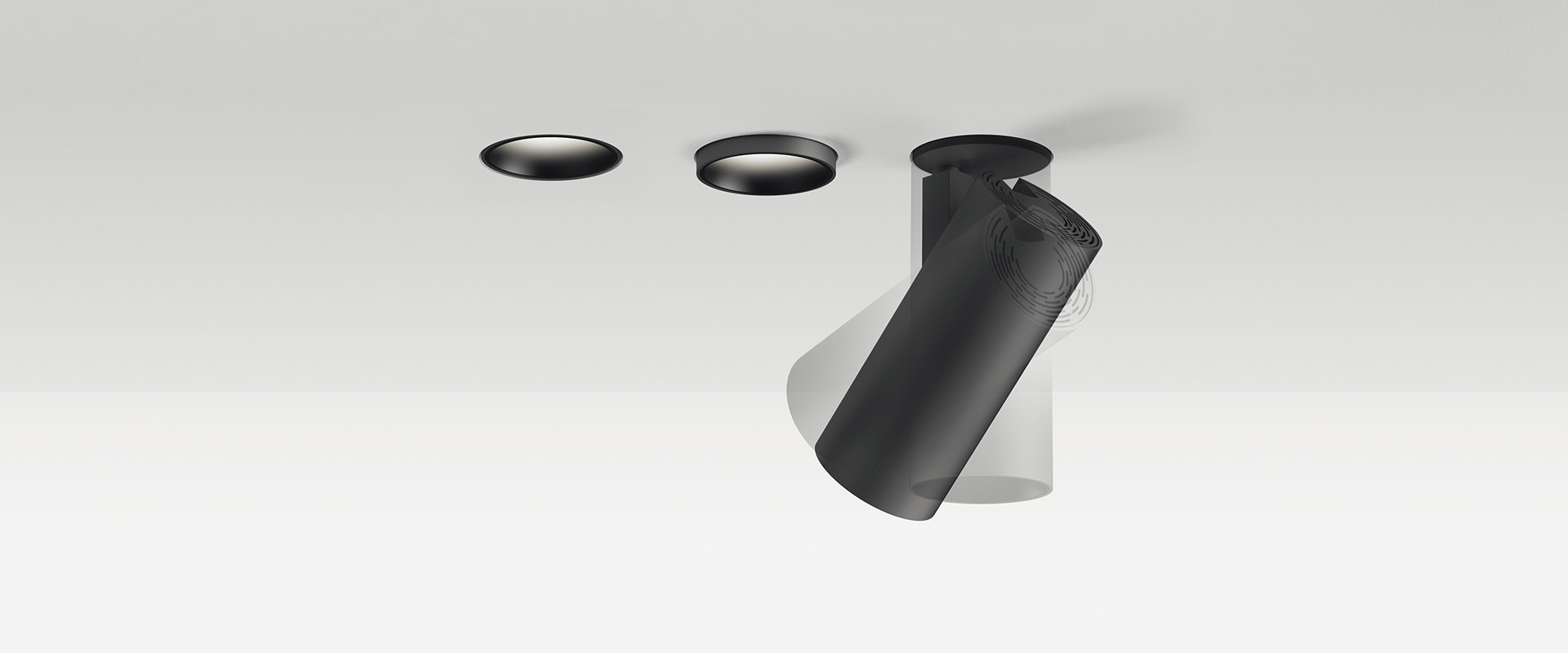 Hand installing a Vector Recessed ceiling spotlight by Artemide, featuring a cylindrical black body flush-mounted into a white ceiling
